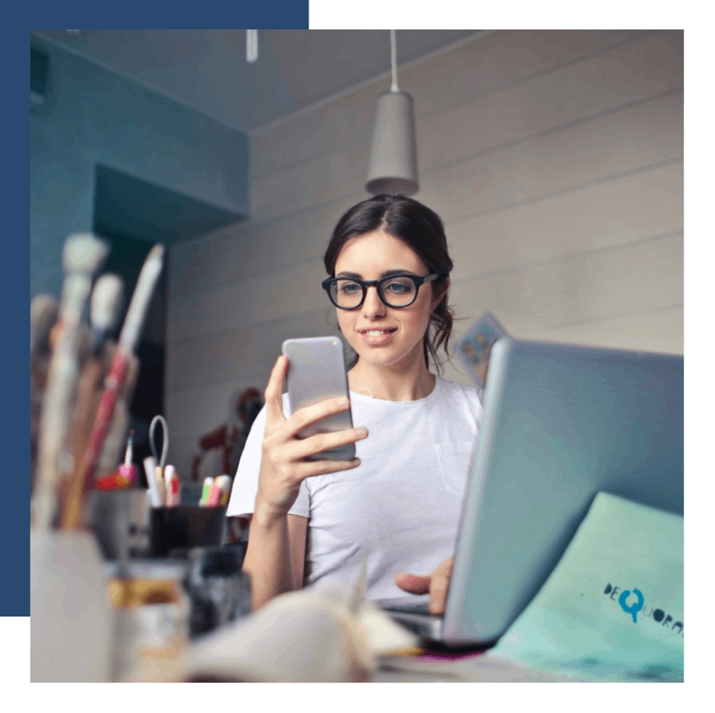 Woman using smartphone at desk