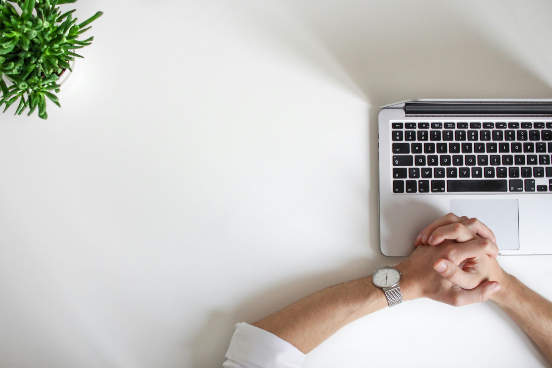 Hands resting on laptop